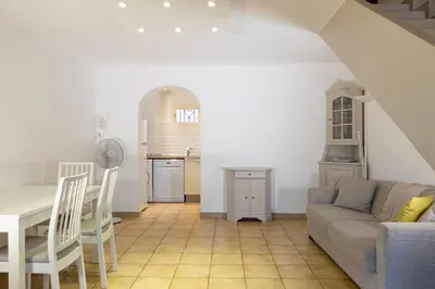 a living room with a couch and a table at Résidence Marie Diane - Grand Duplex H in Propriano