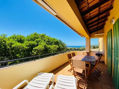 a balcony with a table and chairs on it at Résidence Marie Diane - Laurier des Montagnes in Propriano