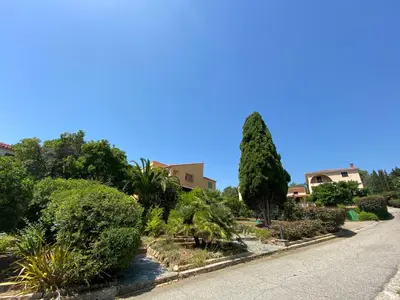 a street with trees and bushes on the side of a road at Résidence Marie Diane - Laurier des Montagnes in Propriano