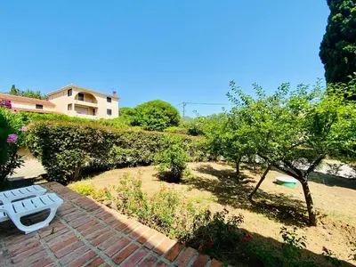 a garden with a bench and a frisbee at Résidence Marie Diane - Laurier Rose in Propriano