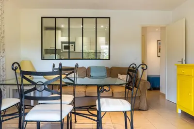 a living room with a couch and a table and chairs at Résidence Marie Diane - Laurier Rose in Propriano