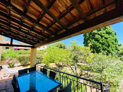 a balcony with a blue table and chairs at Résidence Marie Diane - Laurier Rose in Propriano