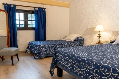 a hotel room with two beds and a window at Duplex vue Piscine B in Propriano