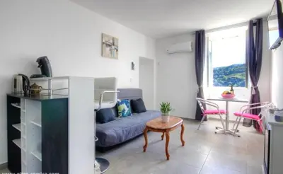 a living room with a couch and a table at Gite Casa di Emma in Santo-Pietro-di-Tenda