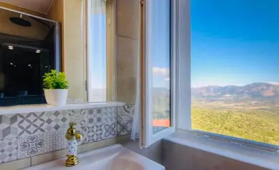 a bathroom with a sink with a large window at Gite Casa di Emma in Santo-Pietro-di-Tenda