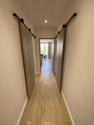 an empty hallway with doors open in a house at Ajaccio Magnifique T2 45m2 neuf 5 personnes Clim wifi stationnement gratuit centre ville plage à 300m in Ajaccio