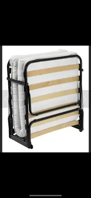 a metal rack with white towels on it at Ajaccio Magnifique T2 45m2 neuf 5 personnes Clim wifi stationnement gratuit centre ville plage à 300m in Ajaccio