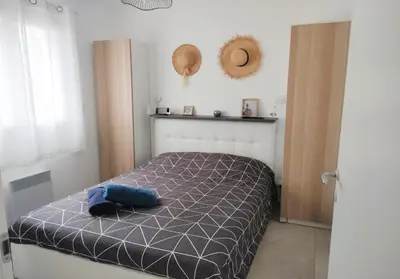 a bedroom with a bed with a blue shirt on it at Résidence Marina Di Bravone in Linguizzetta