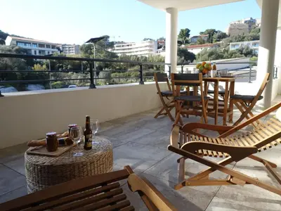 a patio with chairs and tables on a balcony at Apartment Paesu Pimpan by Interhome in Porto-Vecchio