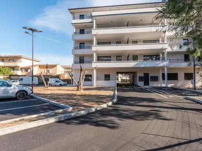 an empty parking lot in front of a building at Apartment Paesu Pimpan by Interhome in Porto-Vecchio