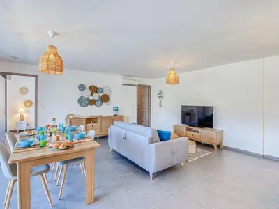 a living room with a couch and a table at Apartment Paesu Pimpan by Interhome in Porto-Vecchio