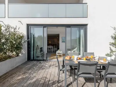 a dining room with a table and chairs on a deck at Apartment château by Interhome in Porto-Vecchio