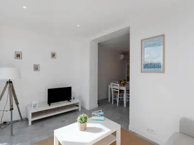 a living room with a couch and a tv at Apartment château by Interhome in Porto-Vecchio
