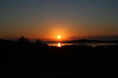 a sunset over the water with the sun in the sky at Villa L'Arbousier 4 pers piscine chauffée 2 min plage en voiture in Sainte-Lucie de Porto-Vecchio