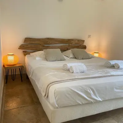 a large white bed with two towels on it at A Machja in Olmiccia
