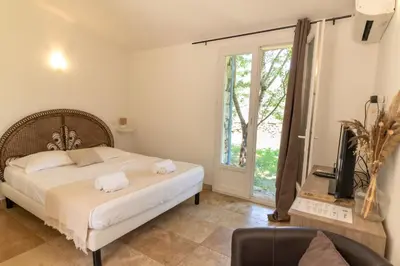 a bedroom with a bed and a large window at A Machja in Olmiccia