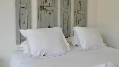 a white bed with white pillows on top of it at A Machja in Olmiccia
