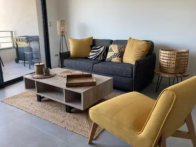 a living room with a couch and a table and chairs at CASA STANATURA in Porto-Vecchio