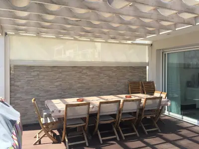 a table and chairs on a patio with a window at Le Loft in Ajaccio