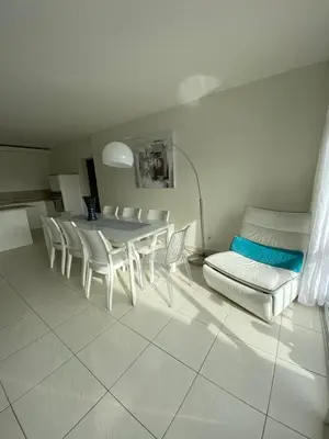 a dining room with a table and chairs and a couch at Le Loft in Ajaccio