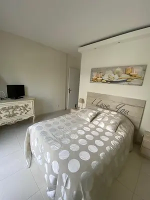a bedroom with a bed with a love sign on it at Le Loft in Ajaccio