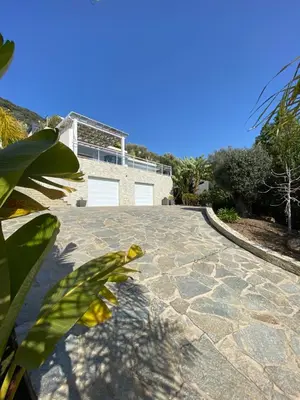 a stone driveway with a house in the background at Le Loft in Ajaccio