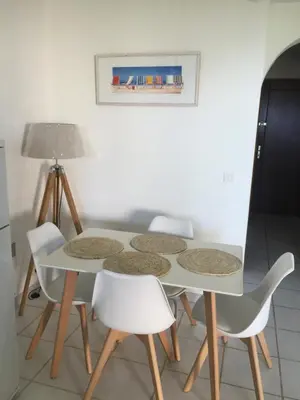 a white table and chairs in a room at Favone Mini Villa Playa del Oro in Favone