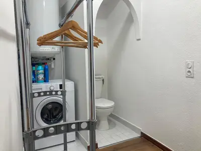 a bathroom with a washer and dryer in a room at Charmant T2 au coeur de la rue Fesch in Ajaccio