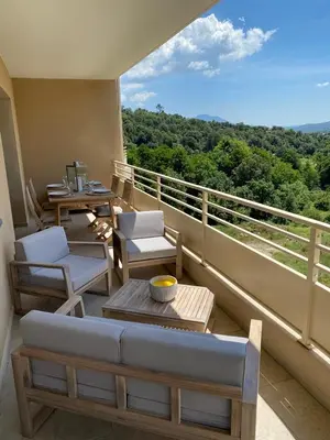 a balcony with a table and chairs and a view at Appartements de Standing - Panate in Corte