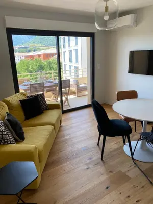a living room with a couch and a table at Appartements de Standing - Panate in Corte
