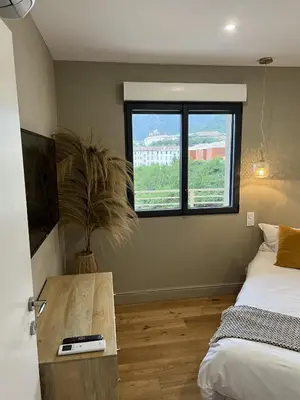 a bedroom with a bed and a tv and a window at Appartements de Standing - Panate in Corte