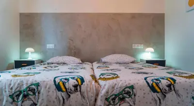 a bedroom with a bed with a dog blanket at Solaneos propose magnifique T4 neuf sur le port avec Piscine CHAUFFEE in Porto-Vecchio