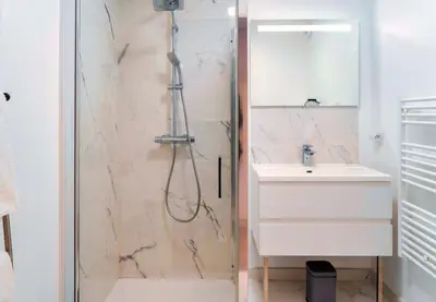 a bathroom with a shower and a sink at Solaneos propose magnifique T4 neuf sur le port avec Piscine CHAUFFEE in Porto-Vecchio