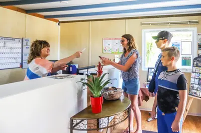 a group of people standing in a waiting room at Camping maeva Escapades Colomba in Olmeto