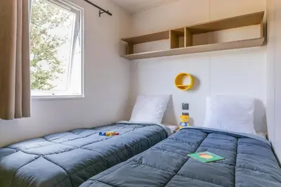 two beds sitting next to each other in a room at Camping maeva Escapades Colomba in Olmeto