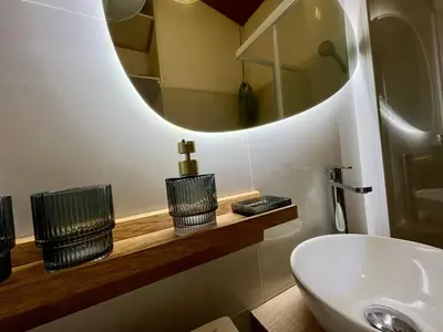 a bathroom with a sink and a mirror at Joli studio maisonnette à 100m de la plage in Porticcio