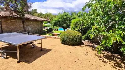 a ping pong table in the yard of a house at Villa Lucendiluna 14 personnes piscine plage 5min le paradis in Sainte-Lucie de Porto-Vecchio