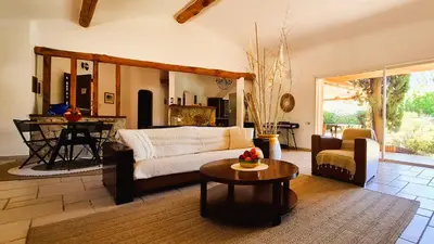 a living room with a couch and a table at Villa Lucendiluna 14 personnes piscine plage 5min le paradis in Sainte-Lucie de Porto-Vecchio