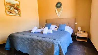 a bedroom with a bed with two stuffed animals on it at Villa Lucendiluna 14 personnes piscine plage 5min le paradis in Sainte-Lucie de Porto-Vecchio