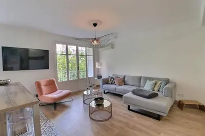 a living room with a couch and a chair at Charmant T2 avec balcon - Parking, AC, Wifi in Ajaccio