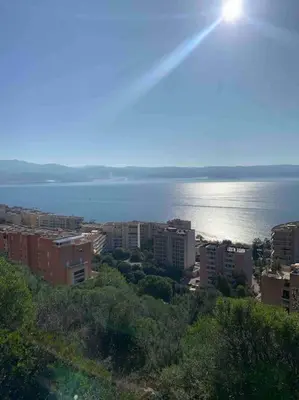 a city with a view of the water and buildings at Appartement neuf, 2 chambres, climatisé, route des Sanguinaires in Ajaccio