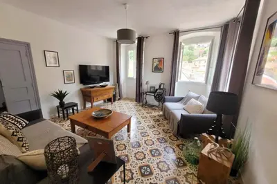 a living room with a couch and a table at Casa Torra in Omessa