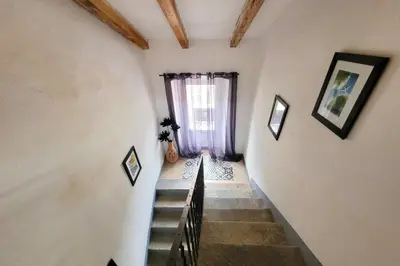a staircase in a house with a window at Casa Torra in Omessa