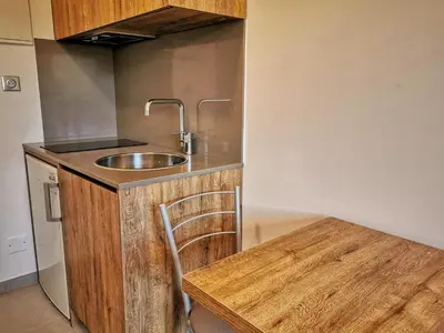 a kitchen with a sink and a wooden table at Ustaria in Peri