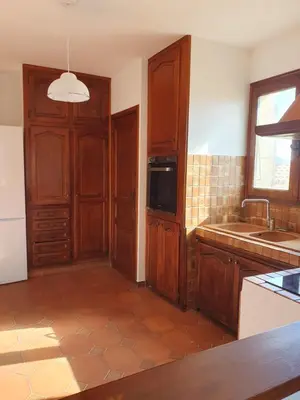 a kitchen with wooden cabinets and a sink at Ustaria in Peri