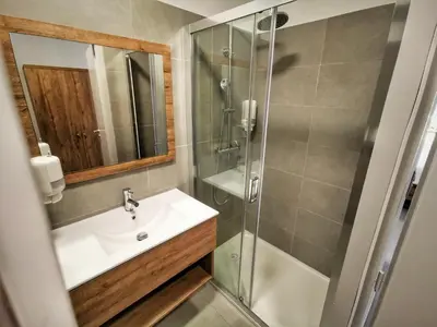 a bathroom with a sink and a shower at Ustaria in Peri