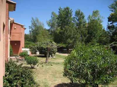 a garden with trees and a building and a house at Liflosa in Lecci