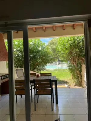 a sliding glass door with a table and chairs at Liflosa in Lecci