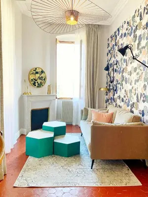 a living room with a couch and two ottomans at U Castellu di A Sulana in Casabianca