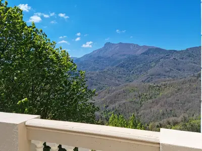 a balcony with a view of a mountain at U Castellu di A Sulana in Casabianca